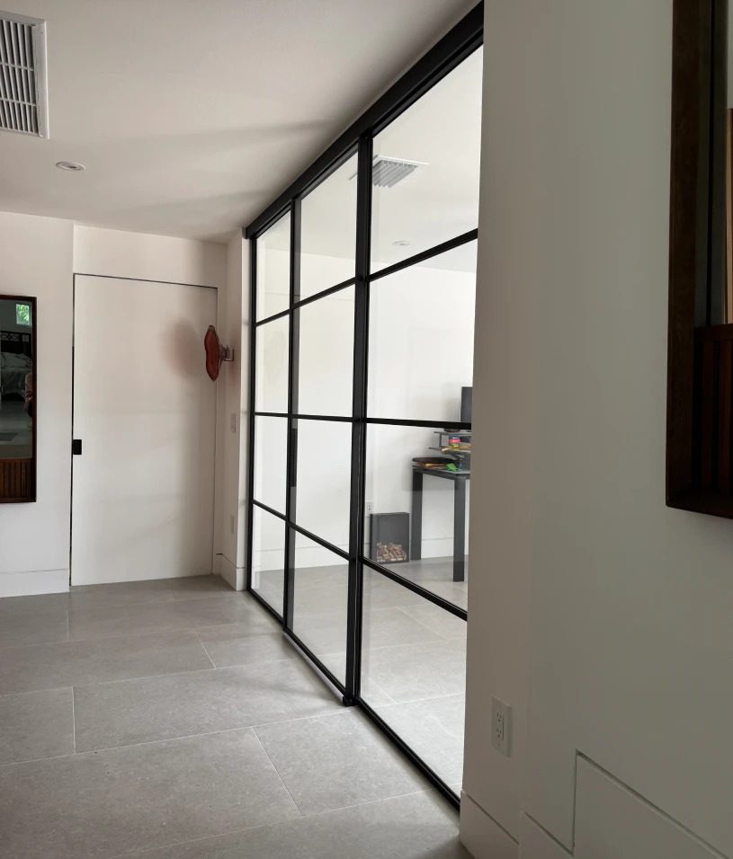 Glass partition in modern hallway